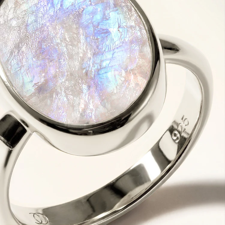 Close-up of a raw moonstone crystal set in polished 925 sterling silver with the 925 hallmark